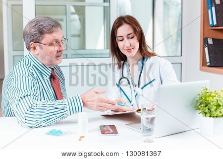 The patient and his doctor in medical office. Healthcare concept