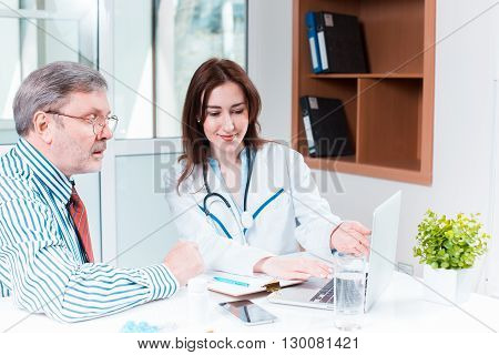 The patient and his doctor in medical office. Healthcare concept