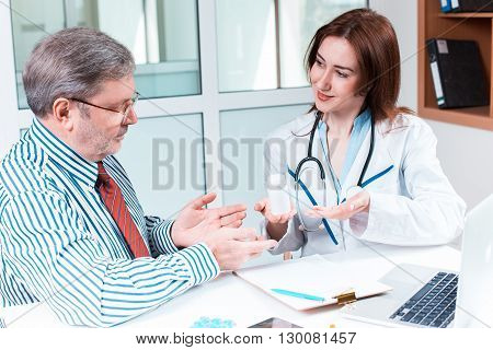 The patient and his doctor in medical office. Healthcare concept