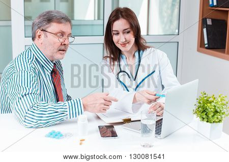 The patient and his doctor in medical office. Healthcare concept