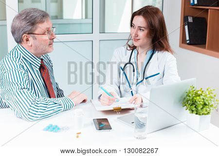 The patient and his doctor in medical office. Healthcare concept