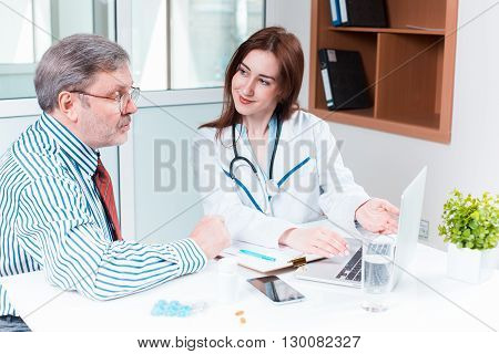 The patient and his doctor in medical office. Healthcare concept