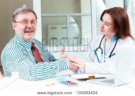 The patient and his doctor in medical office. Healthcare concept