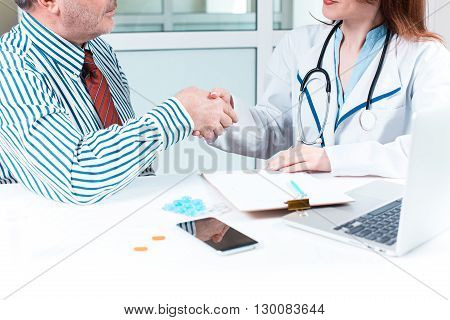 The patient and his doctor in medical office. Healthcare concept