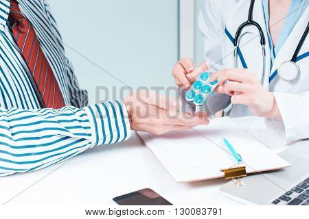 The patient and his doctor in medical office. Healthcare concept