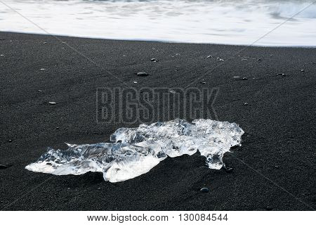 Icebergs on black volcanic sand beach near Jokulsarlon glacier lagoon Southern Iceland