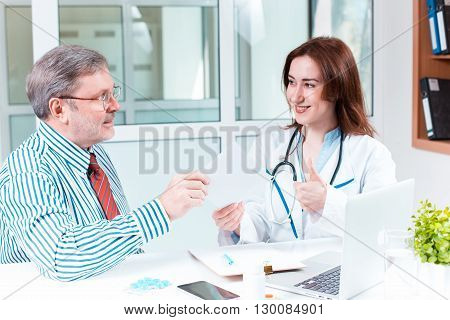 The patient and his doctor in medical office. Healthcare concept