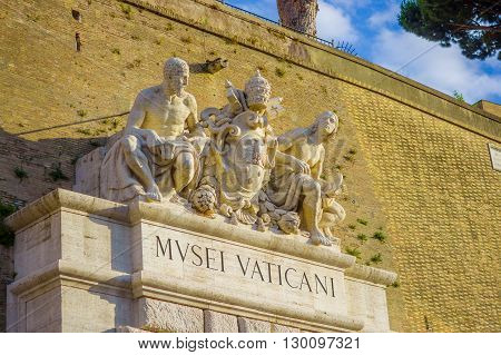 VATICAN, ITALY - JUNE 13, 2015: Wall signboard to enter to Vatican Museums, sculture with Vatican seal on stone.