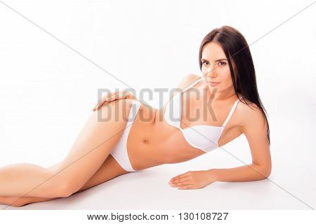 Portrait Of Sensual Pretty Healthy Woman Lying In White Underwear