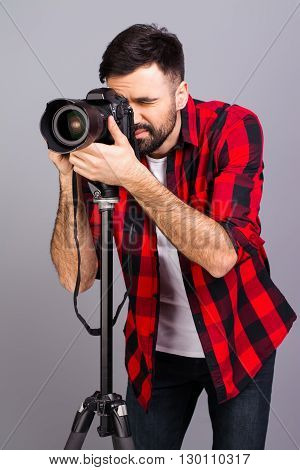 Portrait Of Young Successful Photographer Taking Photos In Studio