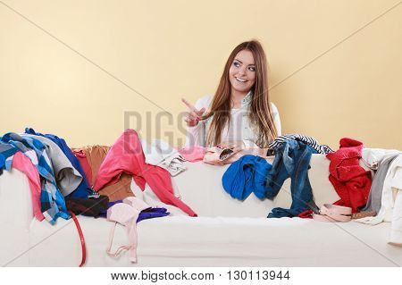 Happy Woman Behind Sofa In Messy Room At Home.