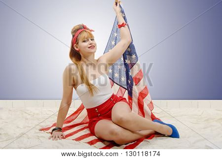 a sexy pin up girl holding an American flag.