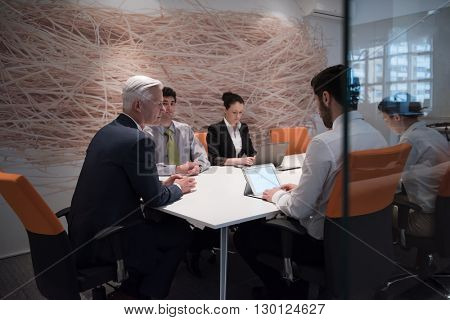 business people group brainstorming on meeting and businessman presenting ideas and projects oon laptop and tablet computer