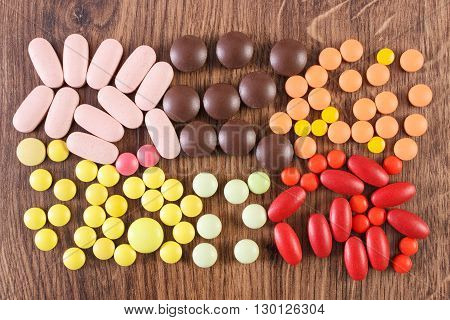 Heap of colorful medical pills capsules or supplements for therapy concept of treatment and health care