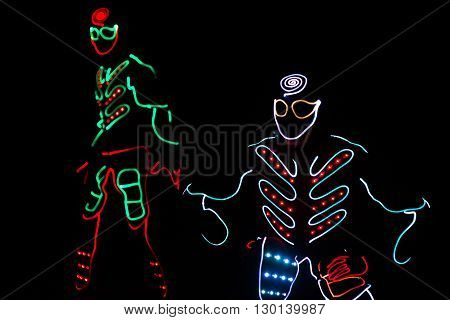 Dancers Crew In Led Suits On Dark Background, Colored Show