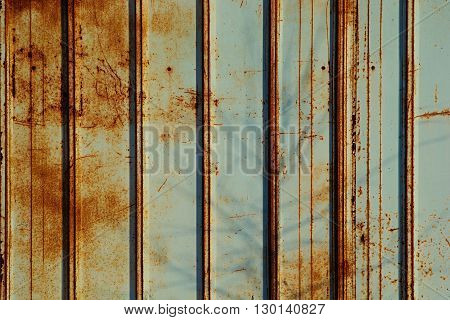 Rusty fence mint color. Mint color background. Rusty metal panel.