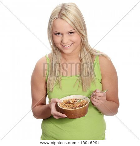 Young corpulent woman eating muslin, isolated on white