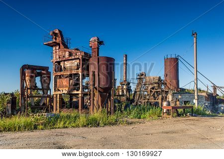 A photo with odl rusty industrial construction and blue clear blue sky
