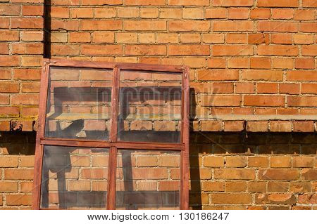 Glazed window frame on the brick wall background