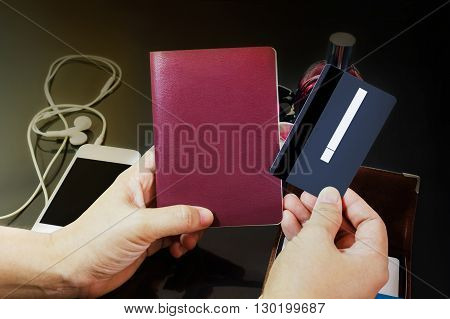 Hands Presenting Back Of Blank Debit Or Credit Card With Empty Signature Area And Blank Passport Wit