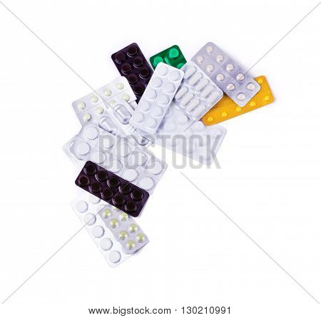 Multicolored medicine pills on the white background
