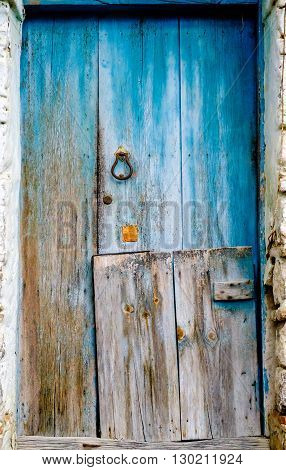 Antique blue wooden door in southern Italy village