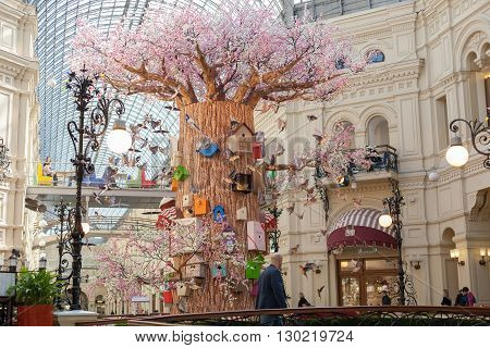 MOSCOW - APRIL 13: The interior decorated artificial tree birds and birdhouses in GUM store on April 13 2016 in Moscow. GUM is the large store in the Kitai-gorod part of Moscow facing Red Square.