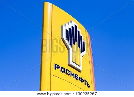 SAMARA RUSSIA - MAY 14 2016: The emblem of the oil company Rosneft against the blue sky background. Rosneft is one of the largest russian oil companies