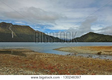 Landscape in the Fjordland National Park New Zealand. Green Lake and mountains.