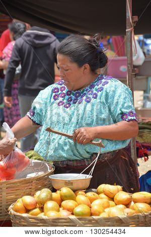QUETZALTENANGO GUATEMALA april 28 2016 : Woman sale fruits in Quetzaltenango maket. This native market is the most colorful in Central America
