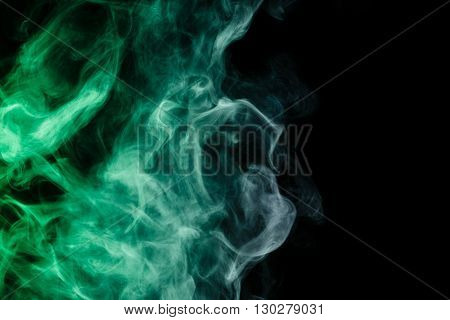 Abstract art. Virid smoke hookah on a black background. Inhalation. The steam generator. The concept of poison gas. Gas.