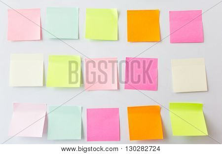 business, information, memo, management and education concept - close up of blank paper stickers on white board