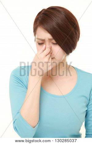 portrait of woman suffers from Asthenopia on white background