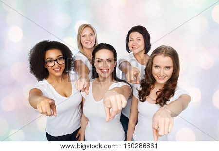 choice, friendship, body positive, gesture and people concept - group of happy different size women in white t-shirts pointing finger on you over holidays lights background