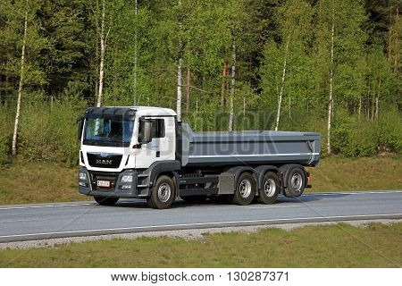 SALO, FINLAND - MAY 13, 2016: White MAN TGS 35.480 tipper truck moves along freeway in South of Finland. The TGS is configured for heavy duty transport.