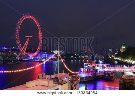 LONDON UNITED KINGDOM - 18 MAY 2016: London Eye is the tallest Ferris wheel in Europe Big Ben and Westminster Abbey in London United Kingdom