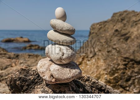 Pebbles stacked up in a pyramid on the sea shore