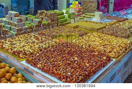 The dessert stall offers gozinaki halva lokum and other traditional sweets Turkish bazaar Akko Israel.