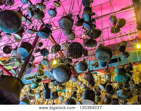 TEL AVIV ISRAEL - FEBRUARY 25 2016: The interior decoration of the famous shakshuka restaurant in old Jaffa with various vintage cookware on the ceiling on February 25 in Tel Aviv.