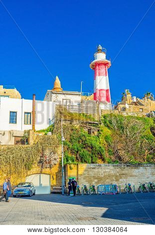 TEL AVIV ISRAEL - FEBRUARY 25 2016: The bright lighthouse rises above the old port of Jaffa on February 25 in Tel Aviv.
