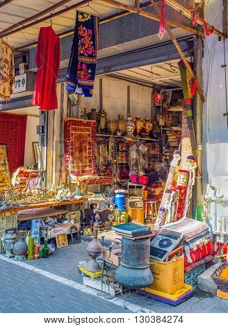 TEL AVIV ISRAEL - FEBRUARY 25 2016: The market stall offers different goods from the colorful carpets to the cookware on February 25 in Tel Aviv.
