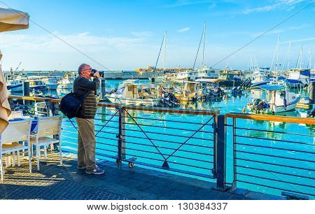 TEL AVIV ISRAEL - FEBRUARY 25 2016: The traveler makes the pictures in port of Jaffa on February 25 in Tel Aviv.