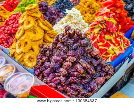 The tasty dried dates pineapple and watermelon slices different raisins in Carmel market of Tel Aviv Israel.