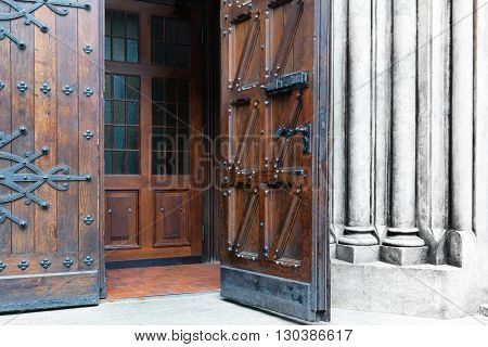 The open old wooden door with metal forging in Medieval Castle