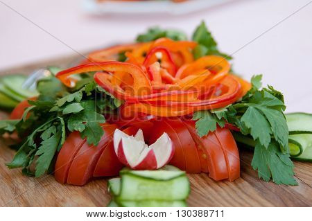 sliced pepper and tomatoes with herbs on the Board