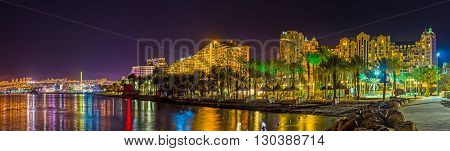 The coast of Eilat in bright illumination reflecting in water Israel.