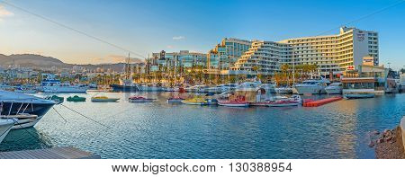EILAT ISRAEL - FEBRUARY 23 2016: Panorama of Lagoona in bright sunset beams with many colorful pleasure boats on February 23 in Eilat.