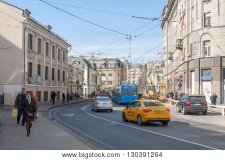 MOSCOW - MARCH 29: Pedestrians taxi trolleybus and cars on Solyanka street on March 29 2016 in Moscow. Solyanka is one of the oldest streets in Moscow.