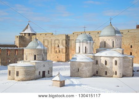 IVANGOROD, RUSSIA - MARCH 02, 2016: St. Nicholas Church and Cathedral of the assumption within the walls of the Ivangorod fortress, winter day.  Historical landmark of the Russia