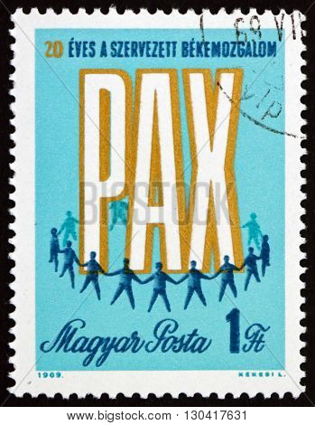 HUNGARY - CIRCA 1969: a stamp printed in Hungary shows PAX and Men Holding Hands 20th Anniversary of Peace Movement circa 1969